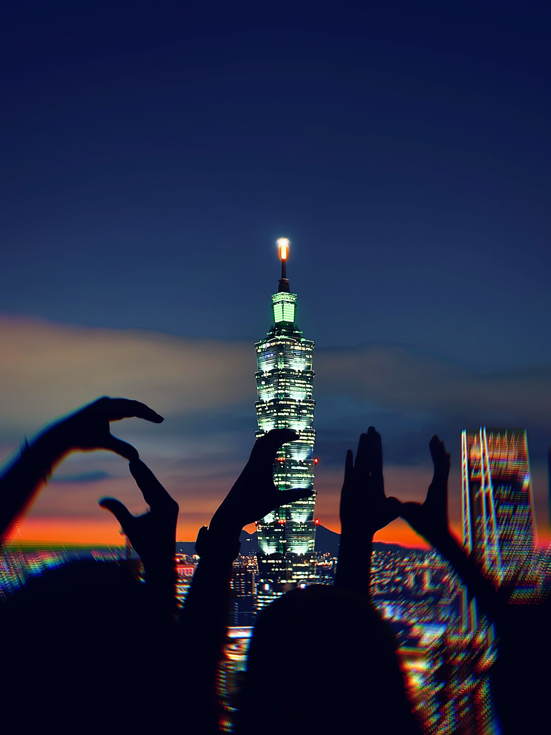 Taipei 101 at night with students in the foreground
