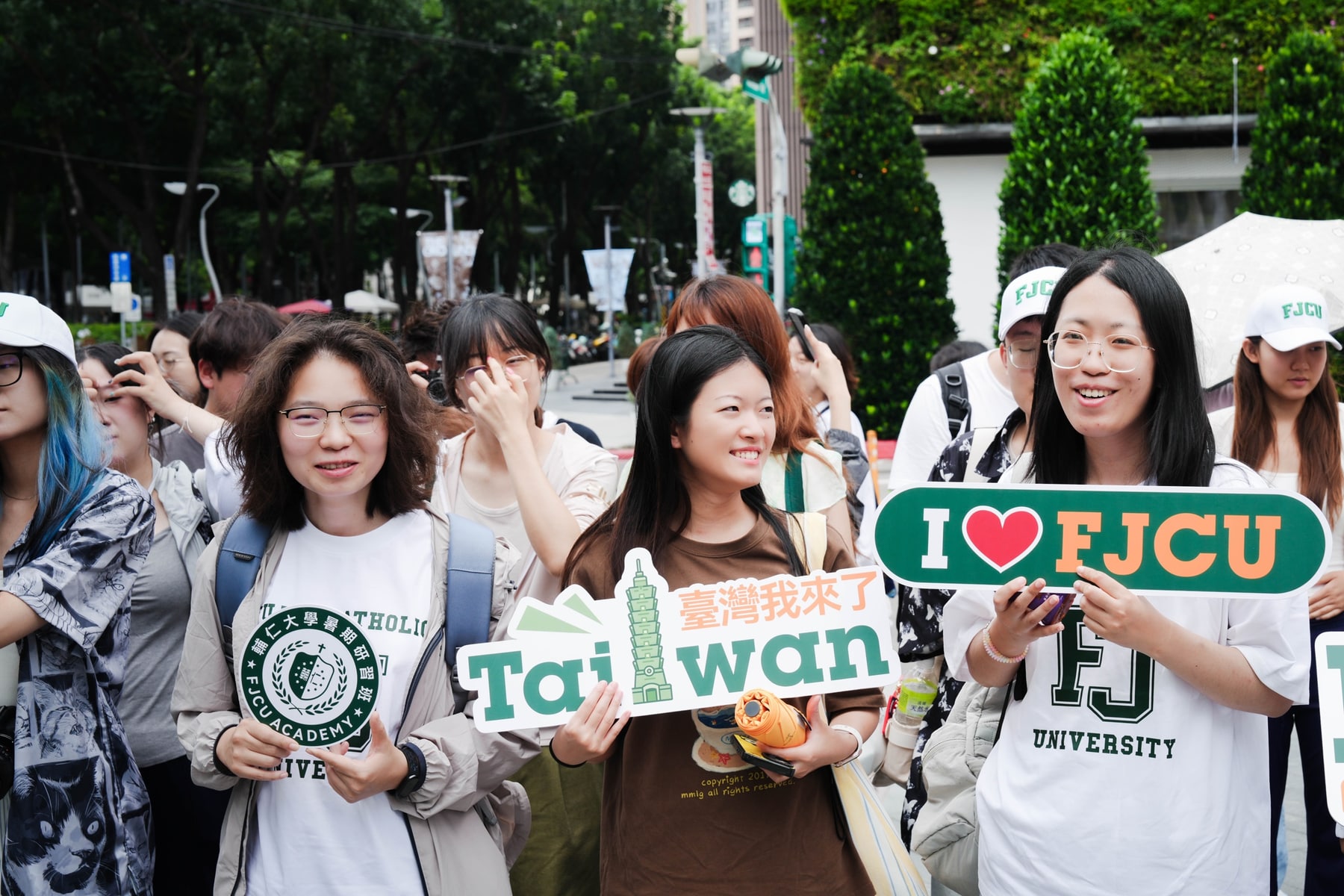 Fu Jen Catholic University program students holding academy signs