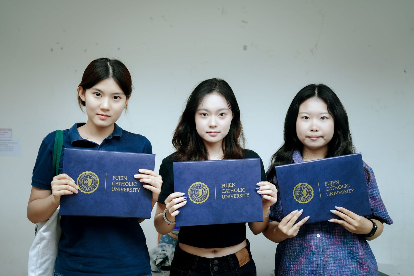 Fu Jen Catholic University students holding their completion certificates