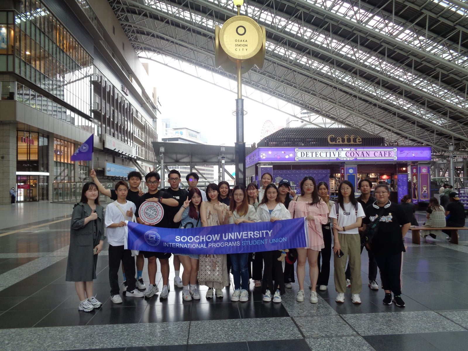 Kansai University students arriving together at a railway station