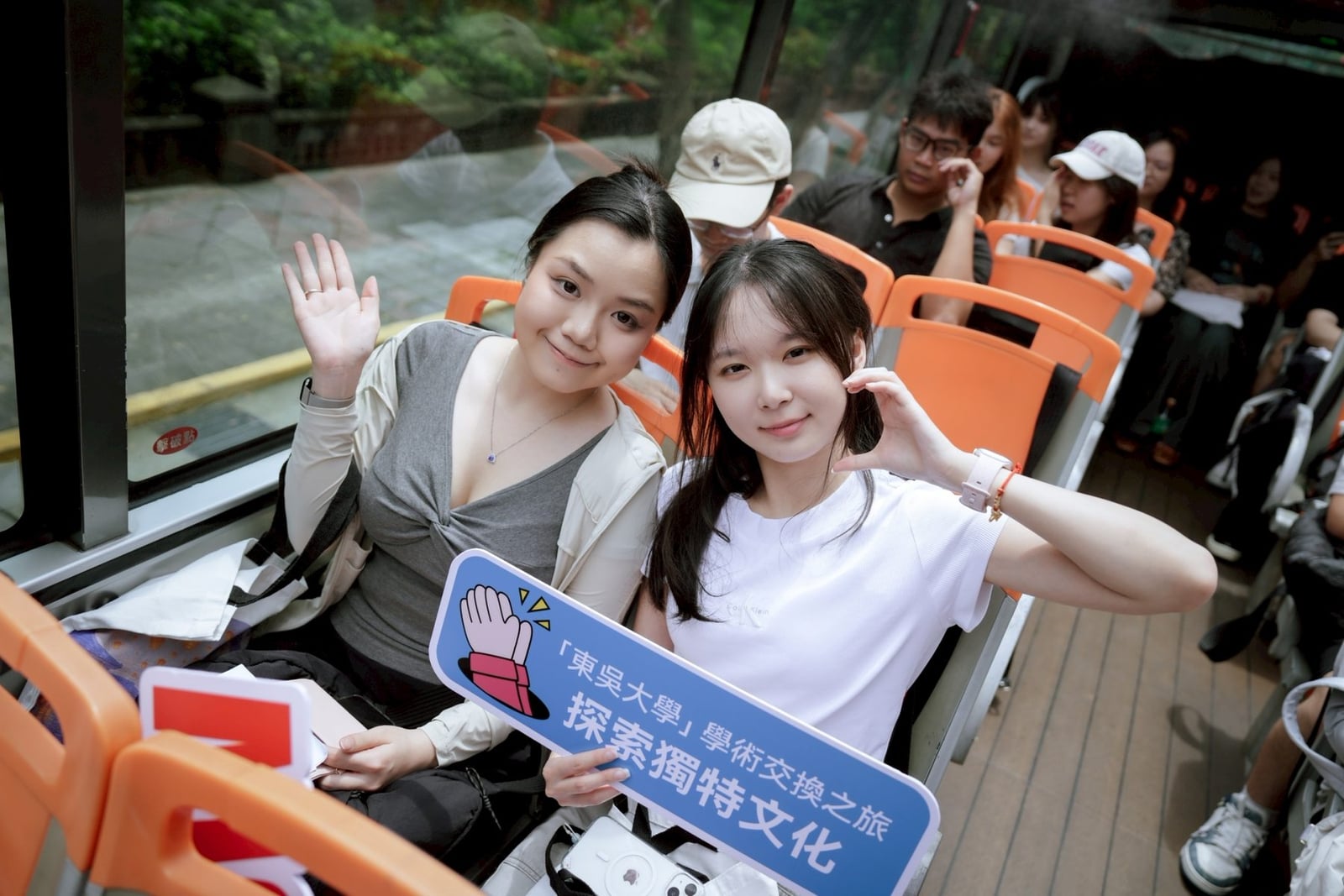 Two Soochow University International Programs students traveling together by bus