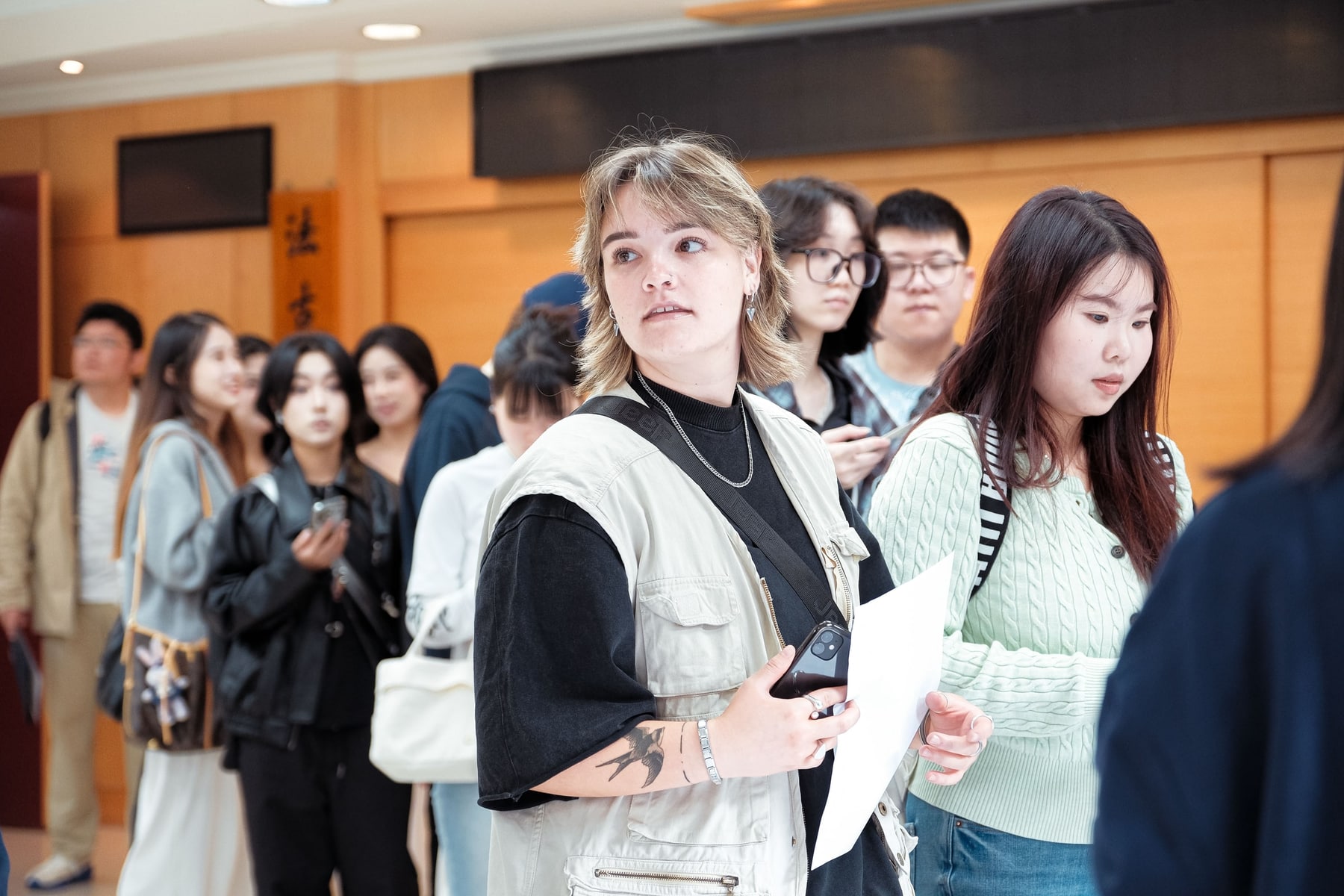 A program coordinator guiding students during on-site registration